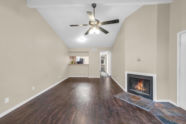 unfurnished living room featuring vaulted ceiling with beams, ceiling fan, dark hardwood / wood-style flooring, and a tile fireplace