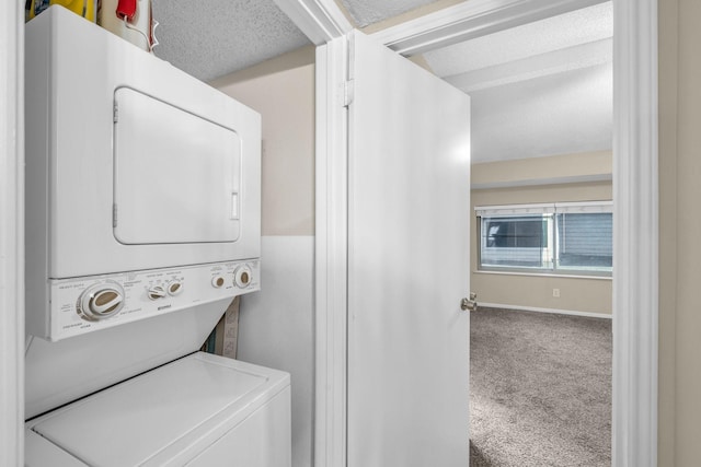 laundry room featuring stacked washer / dryer, carpet flooring, and a textured ceiling