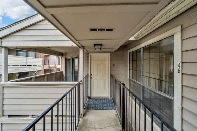 view of exterior entry featuring a balcony