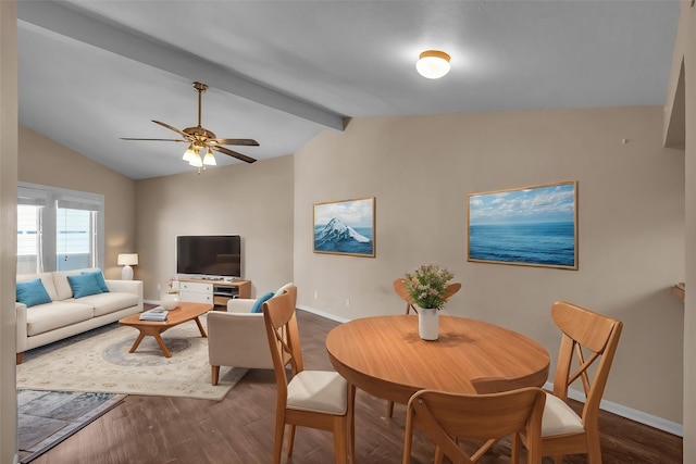 dining area with ceiling fan, wood-type flooring, and vaulted ceiling with beams