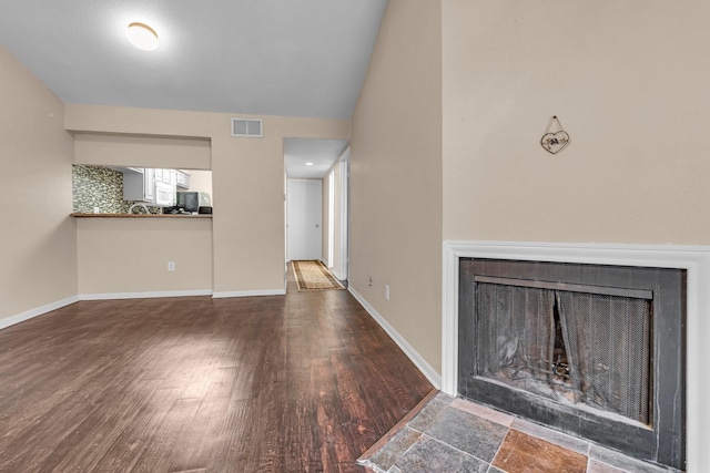 unfurnished living room featuring dark wood-type flooring