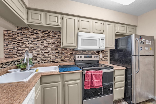 kitchen with decorative backsplash, a textured ceiling, stainless steel appliances, and sink