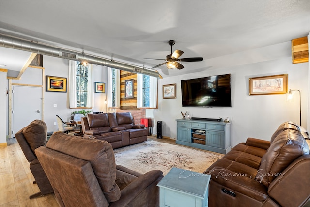 living room featuring ceiling fan and light hardwood / wood-style floors