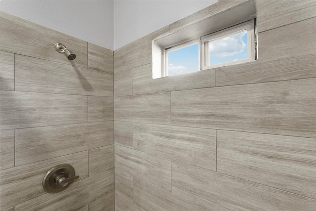 interior details with a tile shower