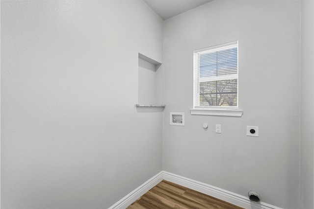 washroom with gas dryer hookup, hardwood / wood-style floors, washer hookup, and hookup for an electric dryer