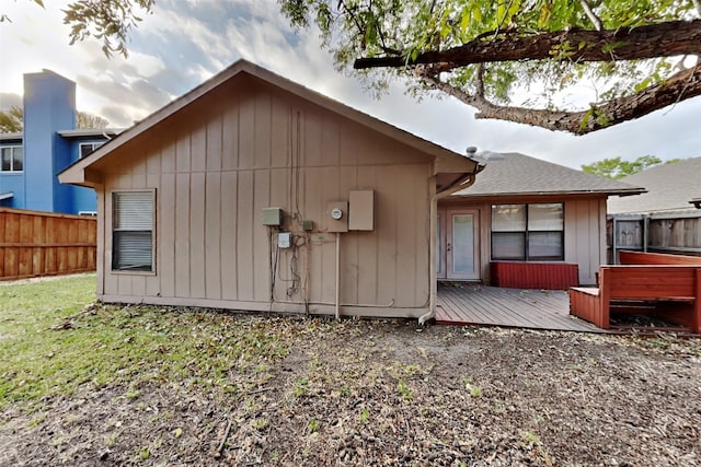 back of house featuring a wooden deck