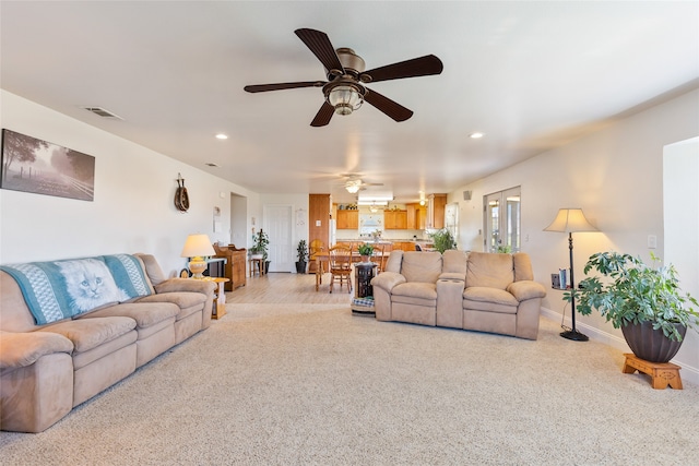 living room with light carpet and ceiling fan