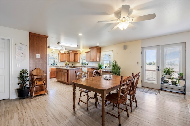 dining space featuring ceiling fan, french doors, and light hardwood / wood-style floors