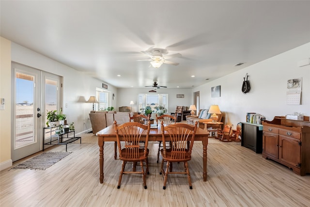 dining room featuring ceiling fan, light hardwood / wood-style floors, and french doors