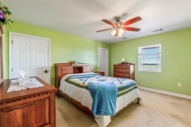 bedroom with ceiling fan and light colored carpet