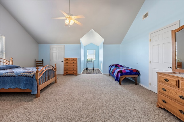 carpeted bedroom featuring ceiling fan and vaulted ceiling