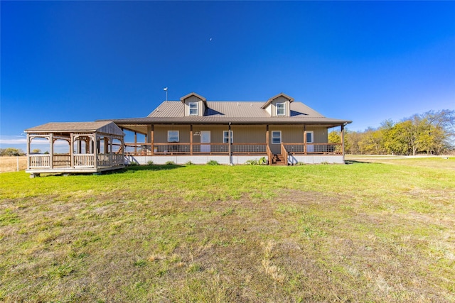 back of property featuring a gazebo and a lawn
