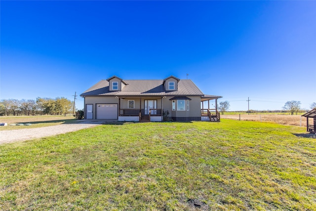 view of front of property featuring a garage, a porch, and a front yard