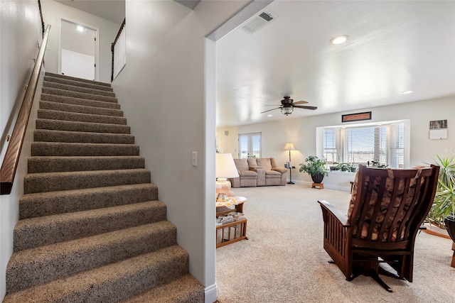 carpeted living room featuring ceiling fan