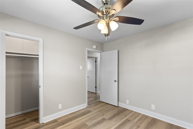 unfurnished bedroom featuring ceiling fan, a closet, and light hardwood / wood-style flooring