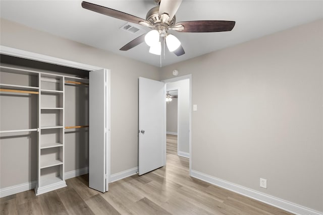 unfurnished bedroom with light hardwood / wood-style floors, a closet, and ceiling fan