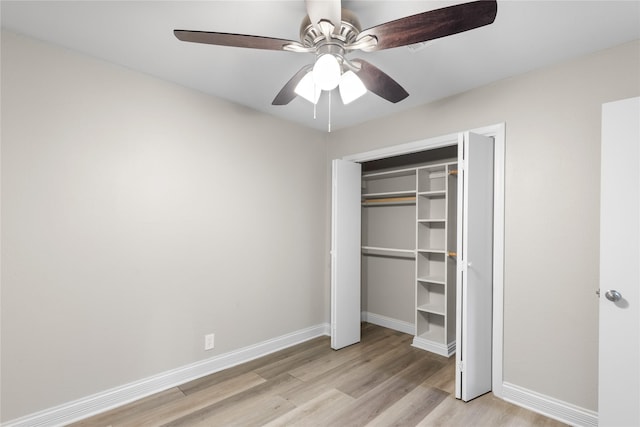 unfurnished bedroom featuring light hardwood / wood-style flooring, a closet, and ceiling fan