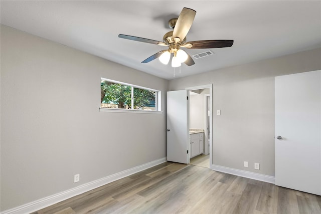 unfurnished bedroom with ceiling fan, connected bathroom, and light hardwood / wood-style flooring