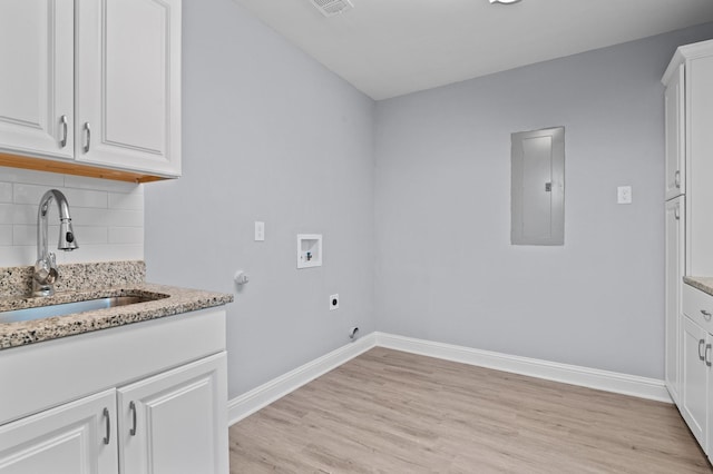 laundry room with sink, cabinets, light hardwood / wood-style flooring, electric panel, and hookup for a washing machine