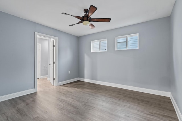 unfurnished room with dark hardwood / wood-style floors and ceiling fan