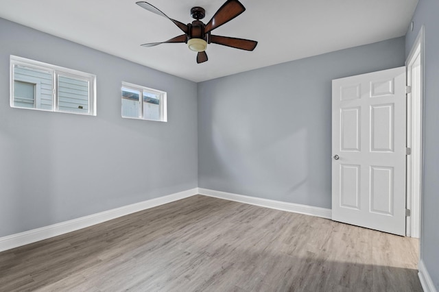 spare room featuring ceiling fan and light hardwood / wood-style floors