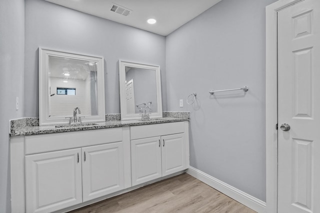 bathroom featuring wood-type flooring and vanity