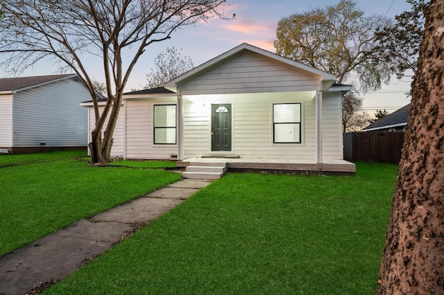 bungalow-style house with a yard