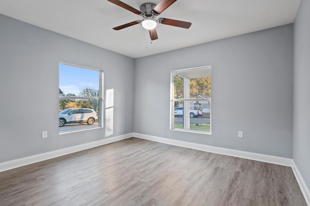 empty room featuring hardwood / wood-style flooring and ceiling fan