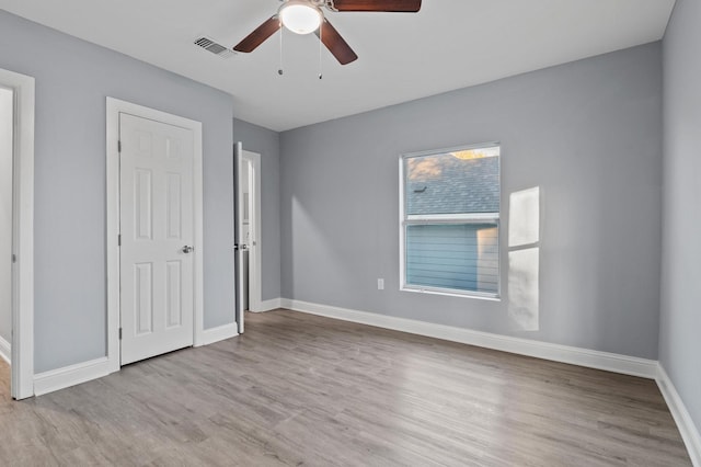 unfurnished bedroom with ceiling fan and light hardwood / wood-style flooring