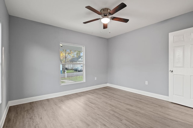 empty room with ceiling fan and light wood-type flooring