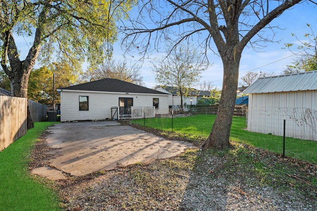 rear view of property with a lawn