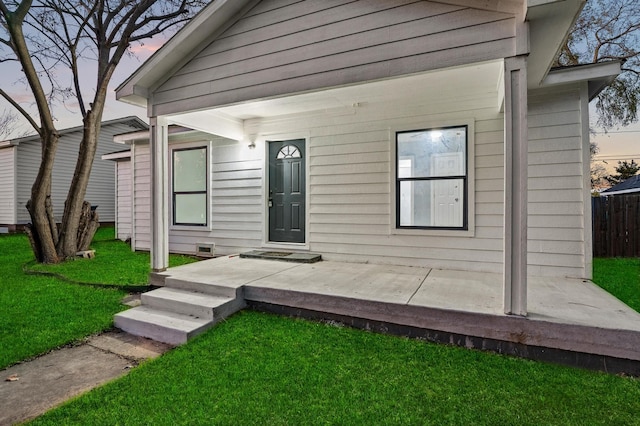 exterior entry at dusk with a yard