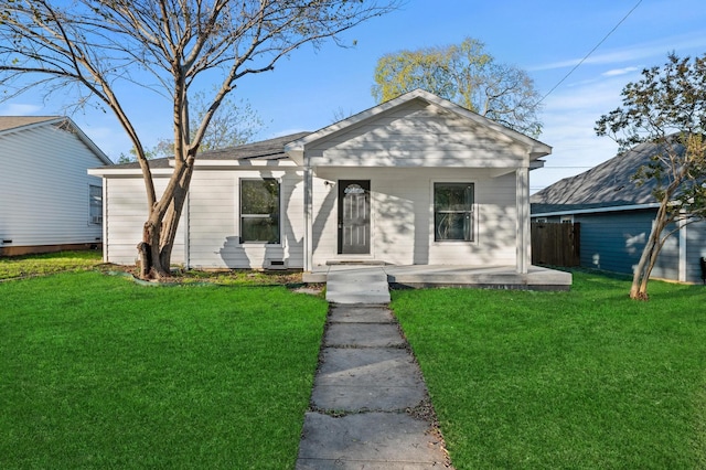 bungalow featuring covered porch and a front yard