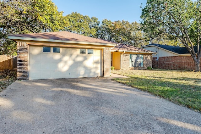 ranch-style house with a front yard and a garage