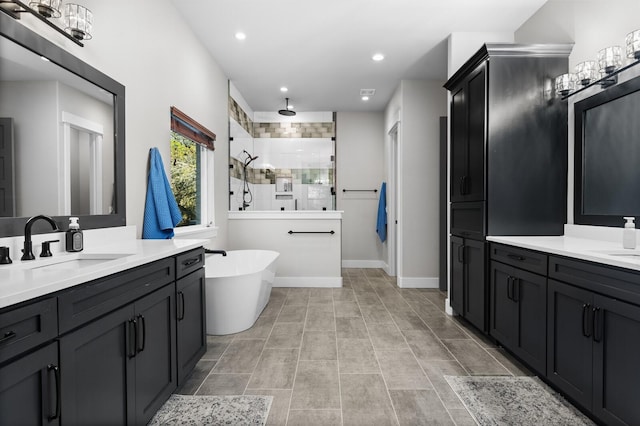 bathroom with vanity and separate shower and tub