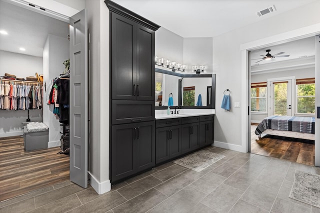 bathroom with vanity, hardwood / wood-style floors, and ceiling fan