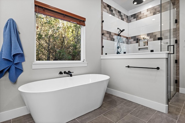 bathroom featuring plus walk in shower and tile patterned floors