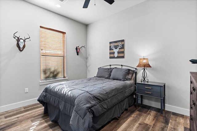 bedroom featuring dark hardwood / wood-style floors and ceiling fan