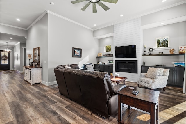 living room featuring a fireplace, plenty of natural light, dark hardwood / wood-style flooring, and ceiling fan with notable chandelier