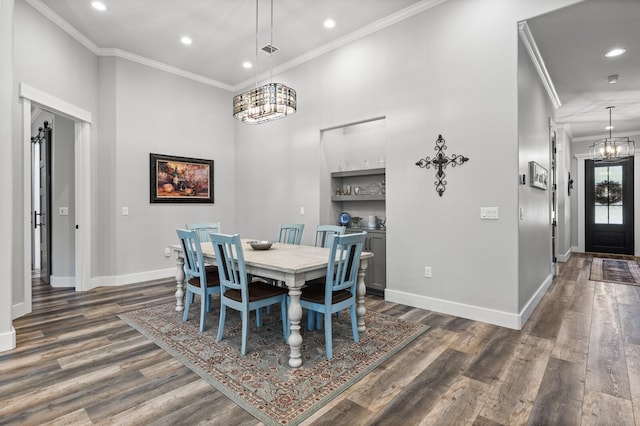 dining space featuring crown molding, dark hardwood / wood-style flooring, and an inviting chandelier