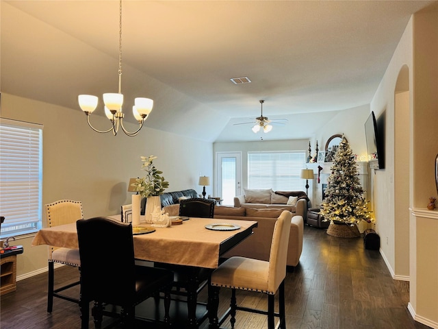 dining room with visible vents, vaulted ceiling, dark wood-style flooring, and ceiling fan with notable chandelier