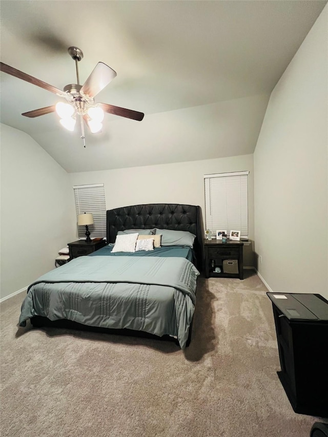 bedroom featuring light carpet, baseboards, vaulted ceiling, and a ceiling fan