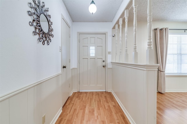 entryway featuring hardwood / wood-style flooring and a textured ceiling