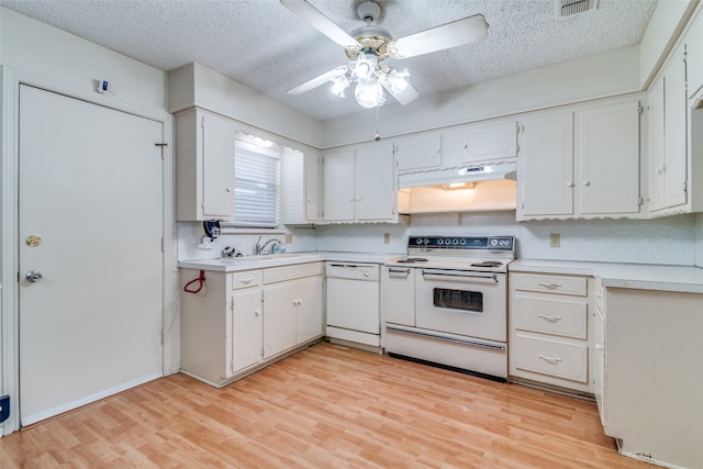 kitchen featuring white cabinetry, white appliances, light hardwood / wood-style flooring, and a textured ceiling