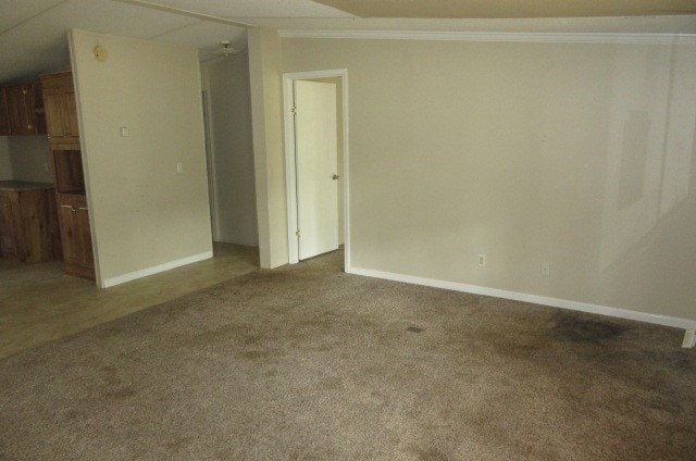 carpeted spare room featuring vaulted ceiling