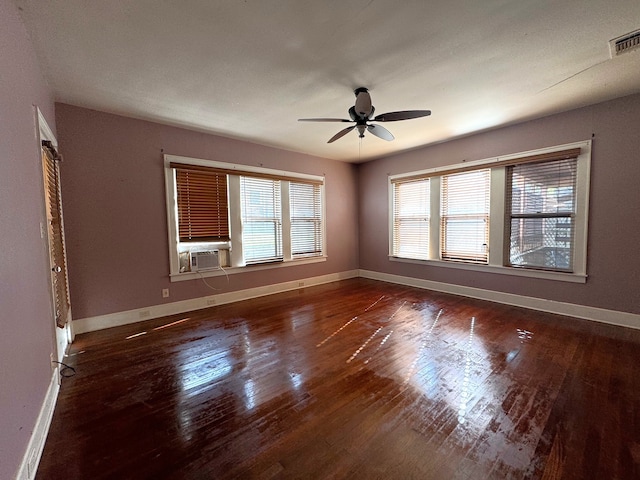 unfurnished room featuring dark wood-type flooring and ceiling fan