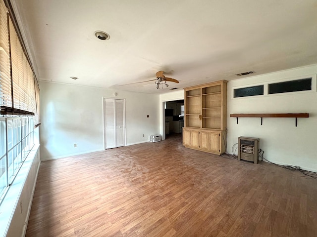 unfurnished living room featuring ceiling fan and wood-type flooring