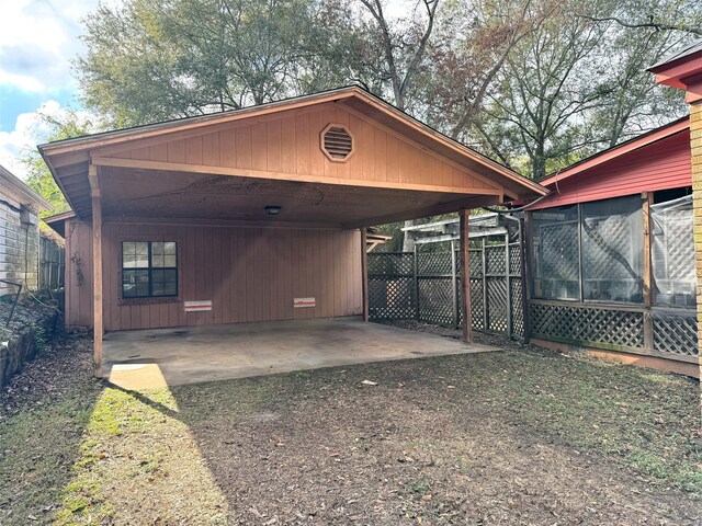 exterior space featuring a carport and a sunroom