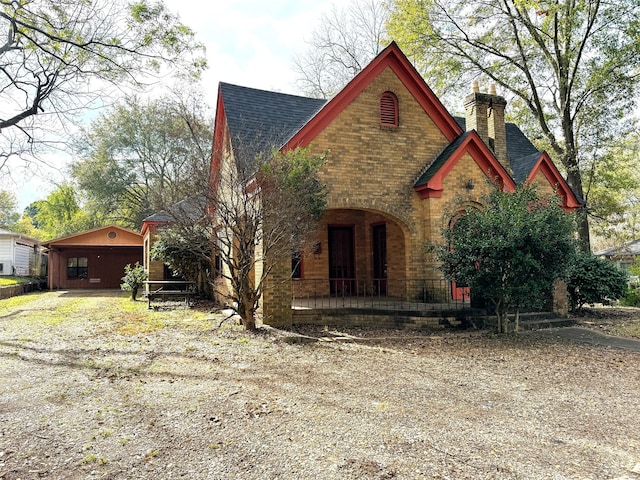 view of front facade with a garage and an outbuilding