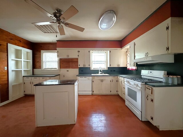 kitchen featuring white cabinets, white appliances, sink, and a wealth of natural light